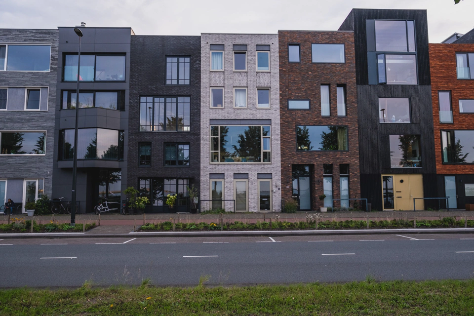 Modern buildings on Ijburg’s promenade next to the Markemeer
